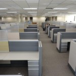 large office area with a bunch of cubicles along each side